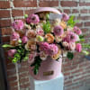Pink and peach rose bouquet in a round pink box