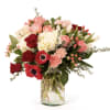 Bouquet of pink and red flowers in a clear glass vase