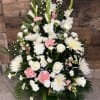 Tall white and pink floral arrangement with roses, carnations, and spider mums