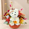 Flower arrangement in a pumpkin container shaped like a teddy bear