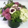 Pink roses and white calla lilies in a green vase