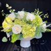 White roses and green hydrangeas in a white vase
