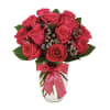 Pink rose bouquet in a clear glass vase with a pink ribbon
