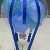 Clear balloon dome with blue balloons and ribbon on a white box