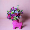 Bright mixed bouquet in a pink roller skate vase