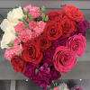 Heart-shaped bouquet of red, pink, and white roses with carnations