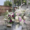 Bouquet of white and purple flowers in a white vase