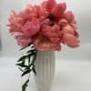 Pink peony bouquet in a tall white vase