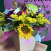Sunflower bouquet with yellow and purple flowers in a gift bag