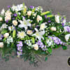 This large half casket spray is made to remember her, featuring a