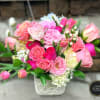 Designed in a elegant stone vase with garden roses and various blooms