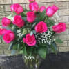 Pink roses arranged in a clear glass vase