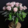 Pink roses arranged in a clear glass vase