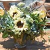 Bouquet of sunflowers and pale yellow tulips in a glass vase