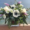 White and pale pink mixed bouquet in a clear glass vase