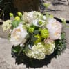 Bouquet of pale pink and white flowers with green accents