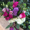 Pink and white mixed bouquet in a purple vase