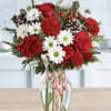 Red roses and white daisies in a glass vase with a ribbon