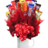 Candy bars arranged in a red gift bouquet in a white mug
