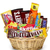 Basket filled with assorted candy bars and candy packs
