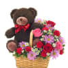 Teddy bear in a basket with pink and red flowers