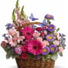Basket of pink, purple, and magenta flowers with butterfly picks