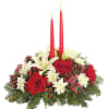 Holiday centerpiece with red roses, white lilies, and two red candles