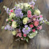 A full, rounded mixed bouquet that feels like a private garden in