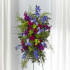 A tall, ceremonial standing spray that reads like a bright sky at