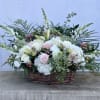 Large basket arrangement of white and pale pink flowers with tall accents