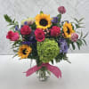 An arrangement for any celebration. Features, sunflowers, roses, hydrangeas, scabiosa and more.