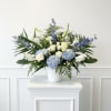 Traditional floor sympathy basket including hydrangea, roses, snapdragon, delphinium, stock and lizianthus.