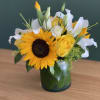 Sunflower and yellow rose bouquet in a glass vase