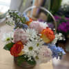 Basket filled with daises, baby's breath, peonies, roses and delphiniums 
(please note