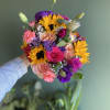 Handheld bouquet with sunflowers, roses, and purple blooms