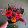 Bright mixed bouquet with gerbera daisies, marigolds, and purple filler flowers