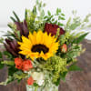 Sunflower and rose arrangement in a square glass vase