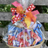 Basket of assorted snack packs wrapped in clear cellophane with colorful ribbon