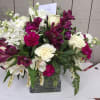 White and magenta mixed bouquet in a square glass vase