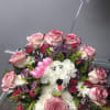 Pink roses and white flowers arranged as a dog with a birthday topper
