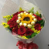 Bouquet of red roses with a sunflower center and gold-wrapped chocolates