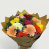 Bouquet of multicolored gerbera daisies wrapped in brown paper