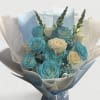 Bouquet of blue and white roses wrapped in pale paper