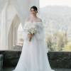 Bride in a white gown holding a white bouquet