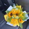 Yellow roses and sunflowers wrapped in white and yellow paper