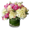 Pink and white roses with hydrangeas in a glass vase