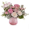 Pink and white flower arrangement in a pink glass vase