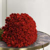 Large bouquet of red roses resting on a round table