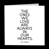 White sympathy card with the words "The ones we love are always in our hearts."