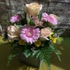 Bouquet of peach roses and pink gerbera daisies in a vase